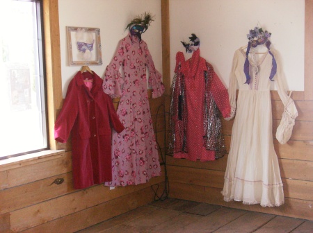 Vintage clothing is displayed with masks made for the Lilac Masquerade Festival 2008.